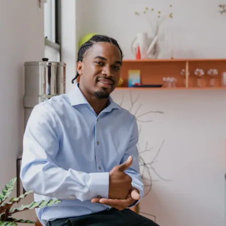 A young man communicates with American Sign Language